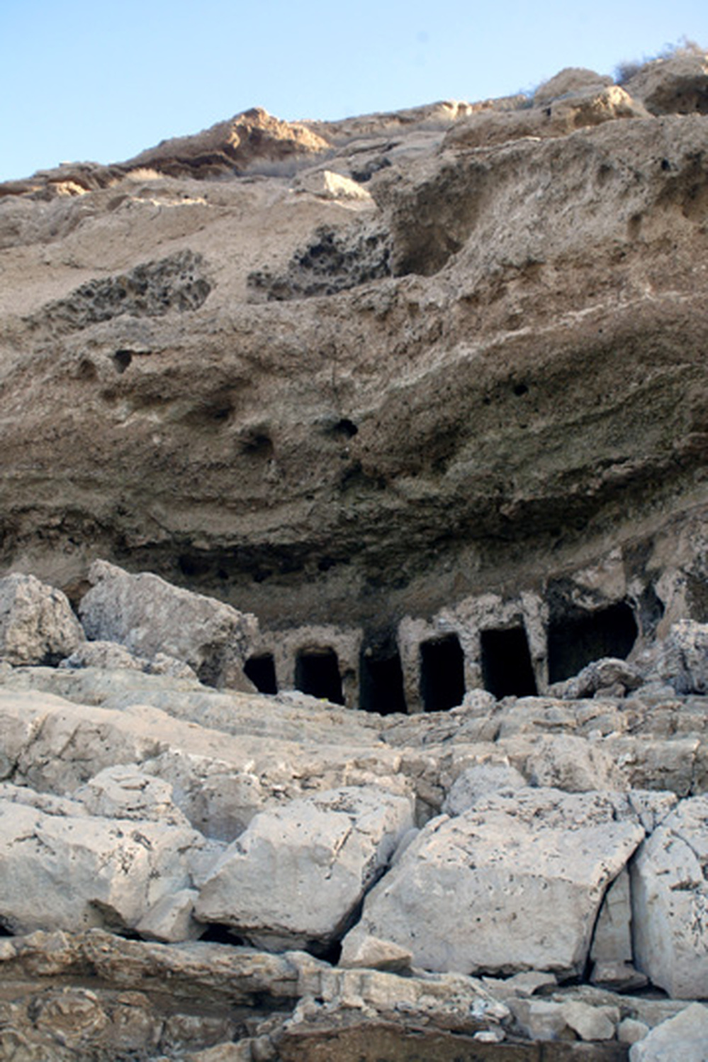 Cliffs that were once submerged now reveal pre-Christian tombs built into the rock face.