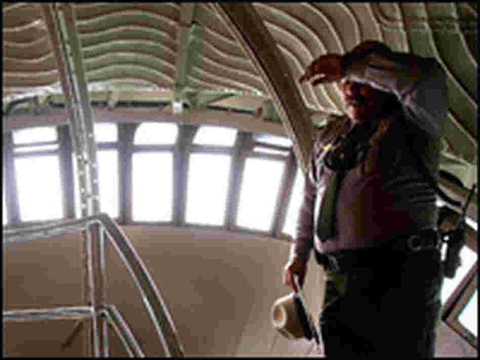 National Park Service park ranger Eugene Kuziw wipes sweat from his brow inside the crown.