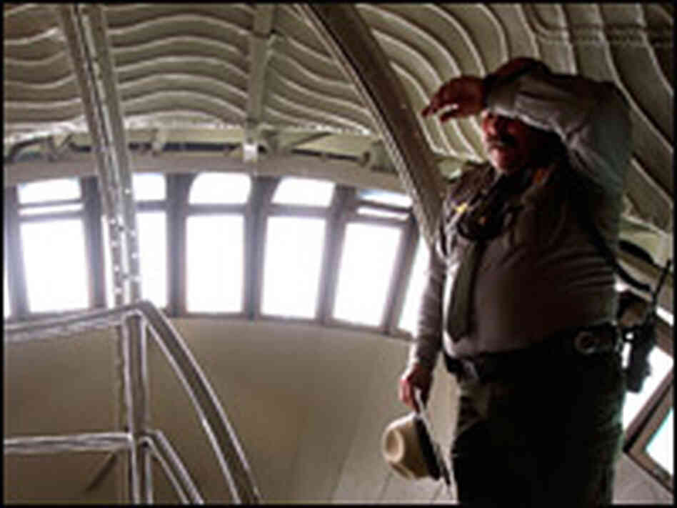 National Park Service park ranger Eugene Kuziw wipes sweat from his brow inside the crown.