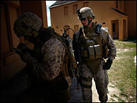 2nd Lt. Samuel Oliver, a platoon leader, checks on a Marine during a training patrol in a replica village, originally designed to look like the Balkans. This will be Oliver's first deployment overseas.
