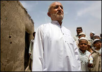 Derwayza Achakzai stands where his wife, Kandahar provincial council member and women's rights activist Sitara Achakzai, was shot and killed outside their home in Kandahar, Afghanistan. Achakzai was returning home on April 12 when four men on two motorcycles drove up and shot her. Bullet holes still mark the outside wall of the building.