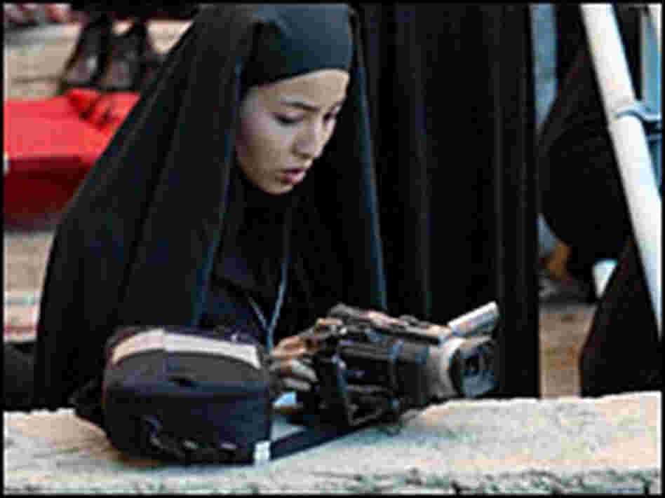 Roxana Saberi videotaping a ceremony in Tehran