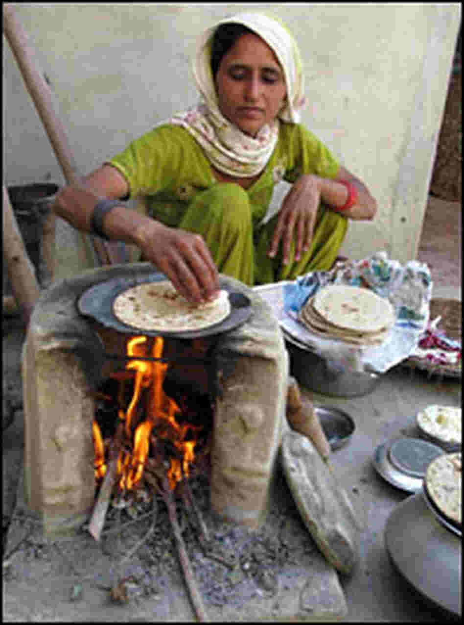 Sharma's daughter-in-law makes chapatis.