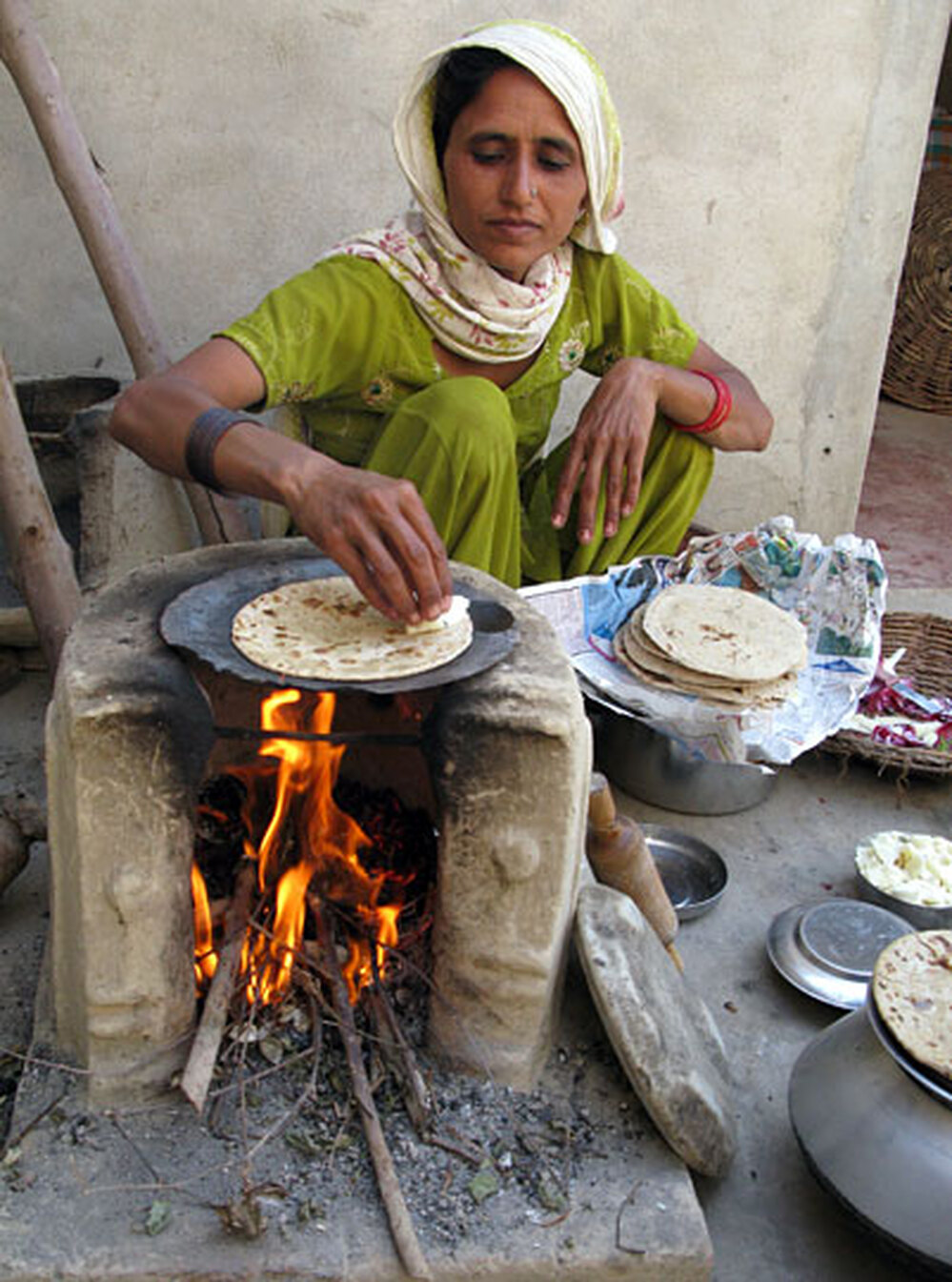 Sharma's daughter-in-law makes chapatis.