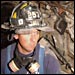 Exhausted firefighter pauses in his search for survivors on 'the pile.' Photo by Andrea Booher, FEMA.