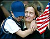 Linda Carter hugs her son Lane at a ceremony near the site of the former World Trade Center, Sept. 11, 2002