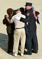 Mourners embrace at Ground Zero