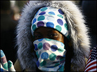 An inauguration spectator is wrapped in her scarf to stay warm. An inauguration spectator is wrapped in her scarf to stay warm.