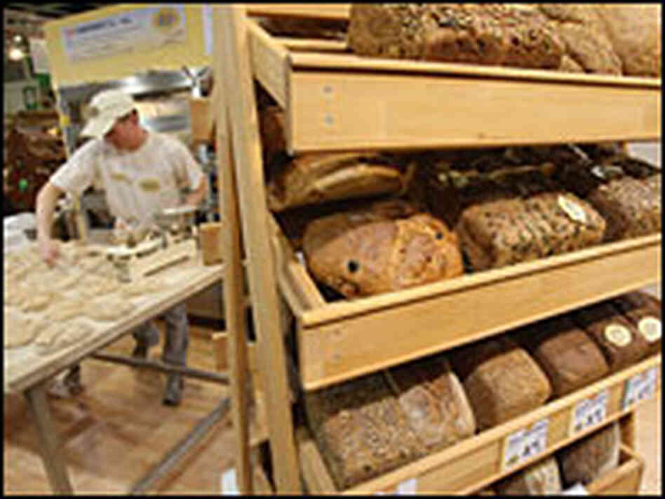 A baker prepares organic bread in Berlin. A baker prepares organic bread in Berlin.
