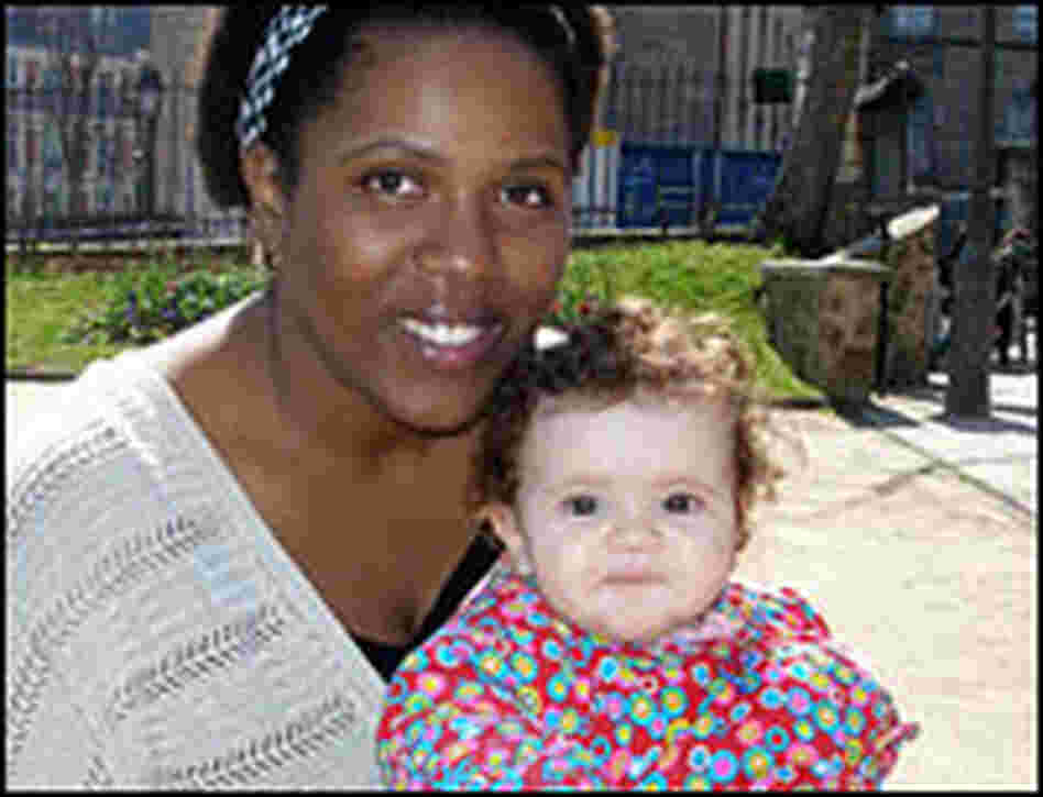 Woman holds child.