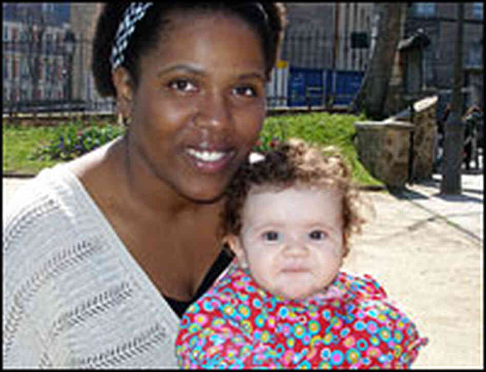 Woman holds child.