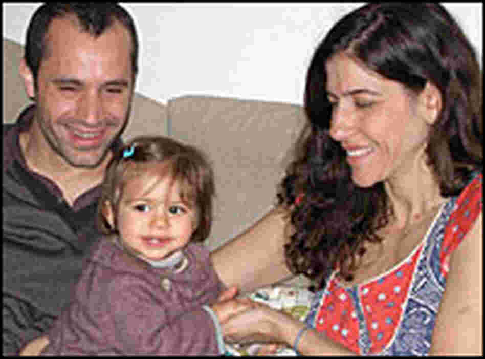 Parents play with child.