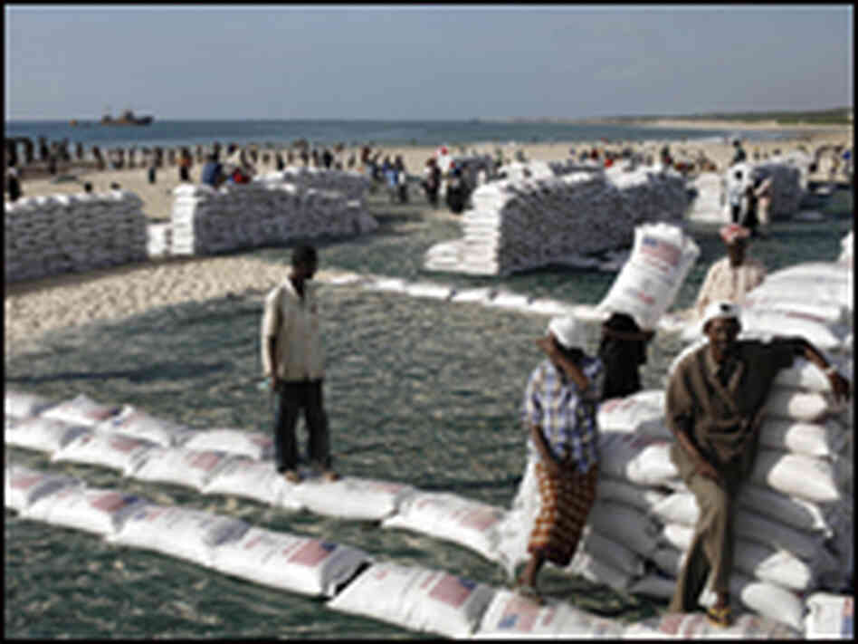 Somalis unload sacks of sorghum provided by the World Food Programme.