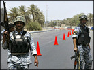 Iraqi police commandos stand guard at Baghdad's airport road on July 5. Iraqi police commandos stand guard at Baghdad's airport road on July 5.
