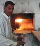 Baking bread at truck stop in Safawi, Jordan
