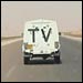 Armored car leads convoy of journalists to Baghdad