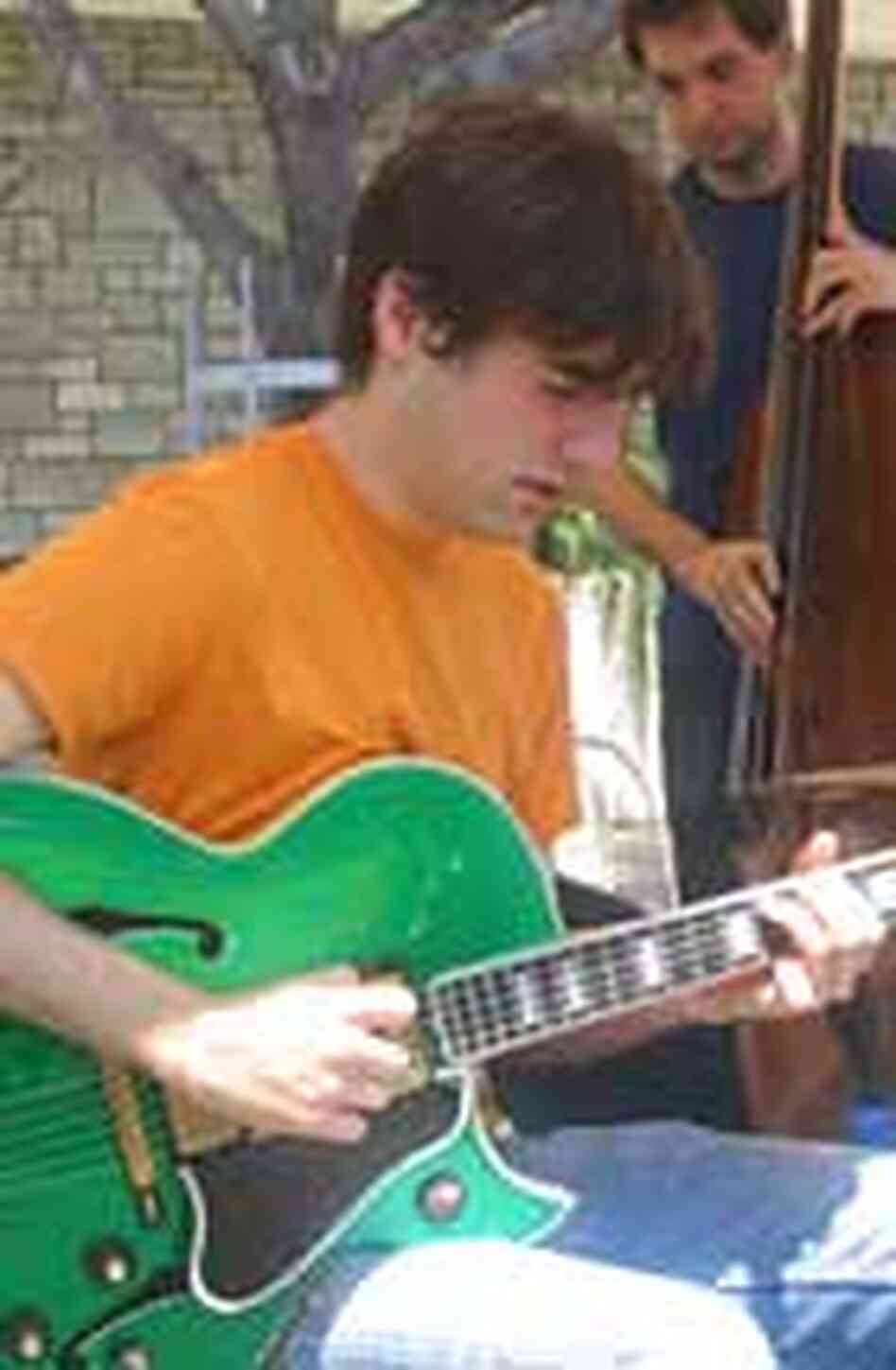 Isaac Darsche, leader of the Isaac Darsche Trio, plays for shoppers at the Westwood Farmer's Market Isaac Darsche, leader of the Isaac Darsche Trio, plays for shoppers at the Westwood Farmer's Market