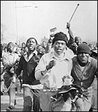 Black students disperse after police open fire on a demonstration against the compulsory teaching of the Dutch-based Afrikaans language in black schools, June 16, 1976.