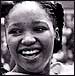 Zinzi Mandela smiles as a crowd in Soweto, South Africa, carries her to the stage, where she read a speech from her jailed father, Nelson Mandela, Feb. 10, 1985. Credit: CORBIS