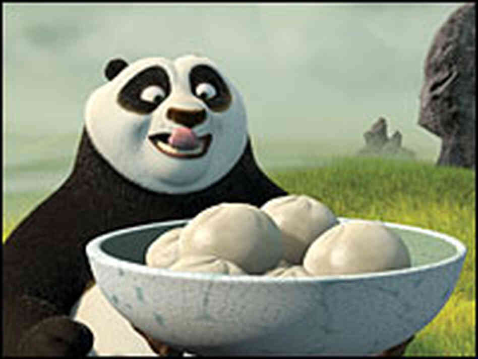 Po (voice of Jack Black) licks his lips, looking at bowl of dumplings