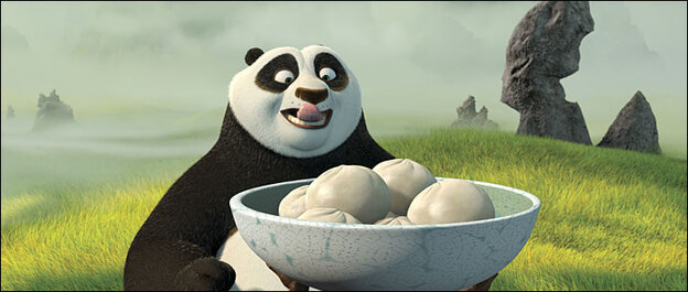 Po (voice of Jack Black) licks his lips, looking at bowl of dumplings