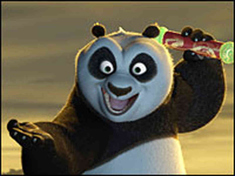 Po the Panda holds the Dragon Scroll in triumph