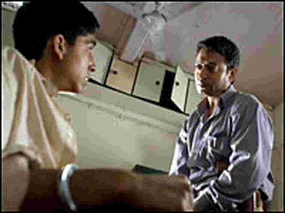 Jamal Malik and Irfan Khan as Police Inspector