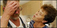 Donald and Colleen Bordelon share an emotional moment in the kitchen of their home in St. Bernard Parish.