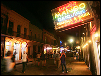 People walk along Bourbon Street in the French Quarter July 26, 2006 in New Orleans.