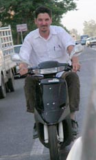 NPR's Guy Raz riding a scooter in Baghdad