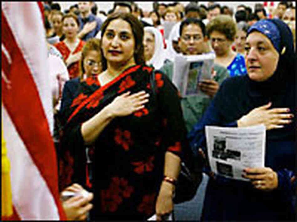 Immigrants pledge allegiance to the United States during a citizenship ceremony. Immigrants pledge allegiance to the United States during a citizenship ceremony.