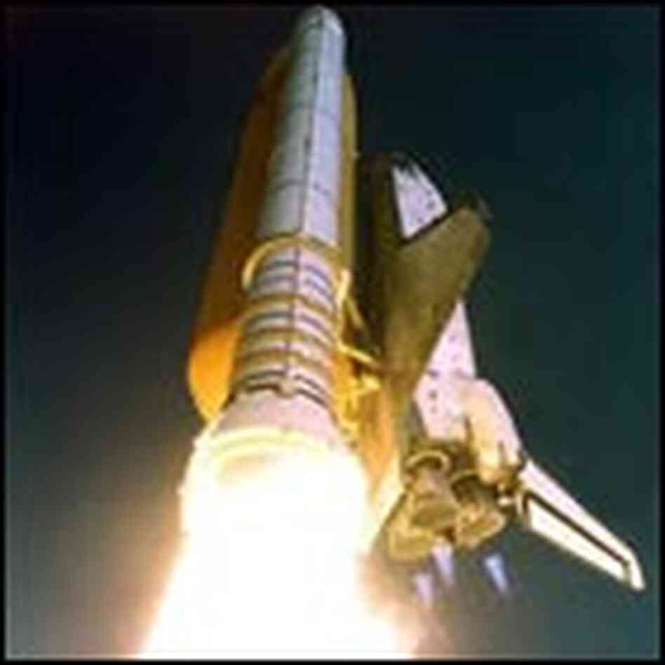 Atlantis hurtles into space on mission STS-112. The shoreline of the Atlantic Ocean is visible in th Atlantis hurtles into space on mission STS-112. The shoreline of the Atlantic Ocean is visible in th