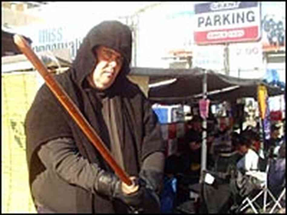 Dressed as a Sith Dark Lord, linesitter Erik stakes out his spot in front of the Chinese Theatre Dressed as a Sith Dark Lord, linesitter Erik stakes out his spot in front of the Chinese Theatre
