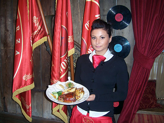 Wait staff clad in red ties are part of the Communist-era theme at Inn Under the Red Hog.