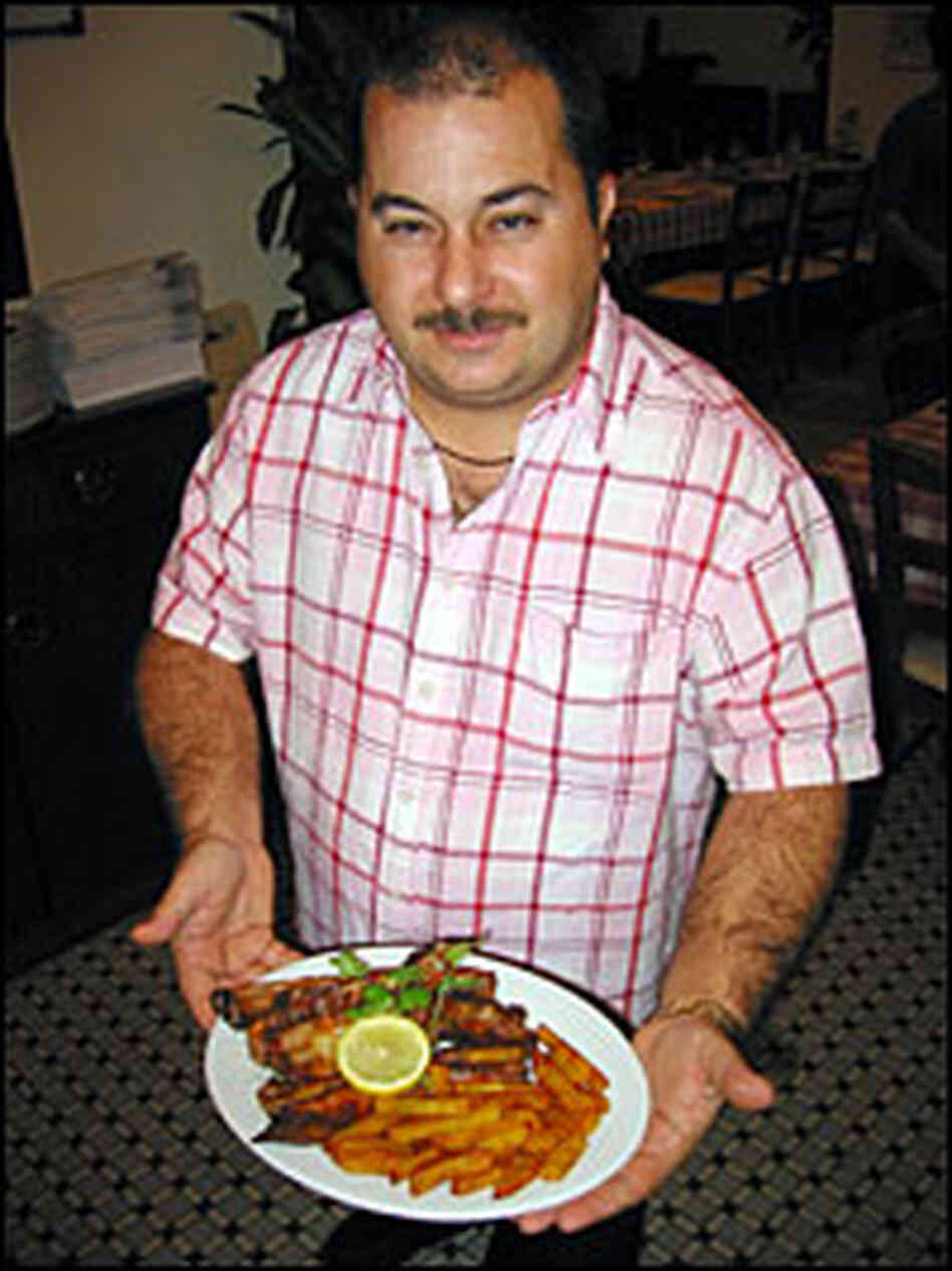 Eusebio Tome is owner of A Petisqueira, a Portuguese restaurant in Macau. He serves a plate of grill