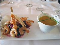 A recent special of the day: pan-fried shrimps with red onions and fresh coriander (shown here with pumpkin soup with spices and mushrooms).