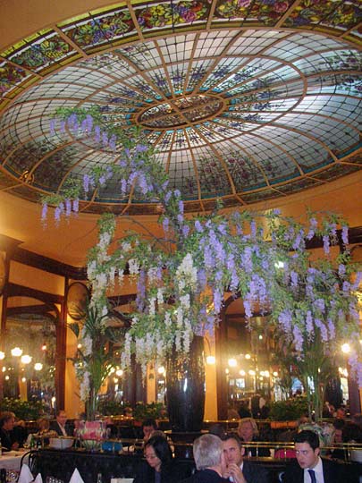 A colorful, domed, stained-glass ceiling adorns the central dining room