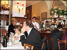 A mix of locals and tourists are packed tightly into Chez Georges cozy dining room. A mix of locals and tourists are packed tightly into Chez Georges cozy dining room.