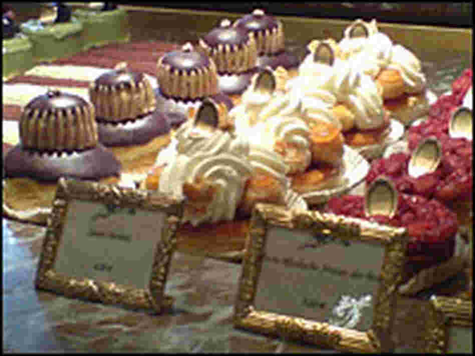 A pastry case contains eclairs, millefeuilles and other mouthwatering desserts.