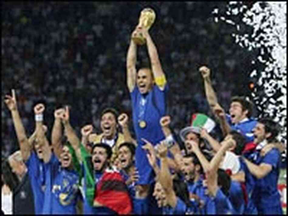 Italian defender Fabio Cannavaro celebrates with the World Cup trophy in Berlin.