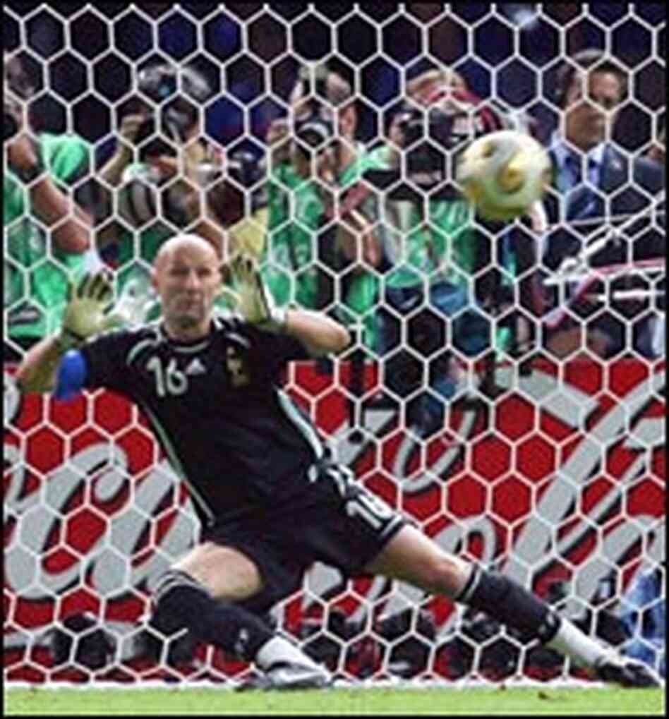 French goalkeeper Fabien Barthez misses a penalty shot by Italian defender Fabio Grosso.