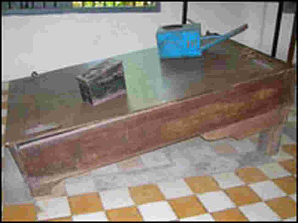 A waterboard and blue watering can used by the Khmer Rouge.
