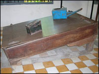 A waterboard and blue watering can used by the Khmer Rouge.