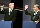 Rep. Dick Gephardt and former Vermont Gov. Howard Dean raise their hands to show they would support the Democratic nominee.