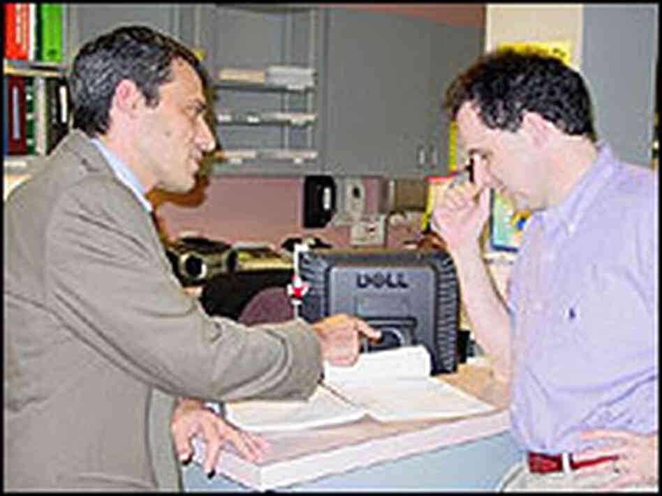 Dr. Thomas Giordano, director of Houston's Thomas Street Health Center, speaks with assistant medica Dr. Thomas Giordano, director of Houston's Thomas Street Health Center, speaks with assistant medica