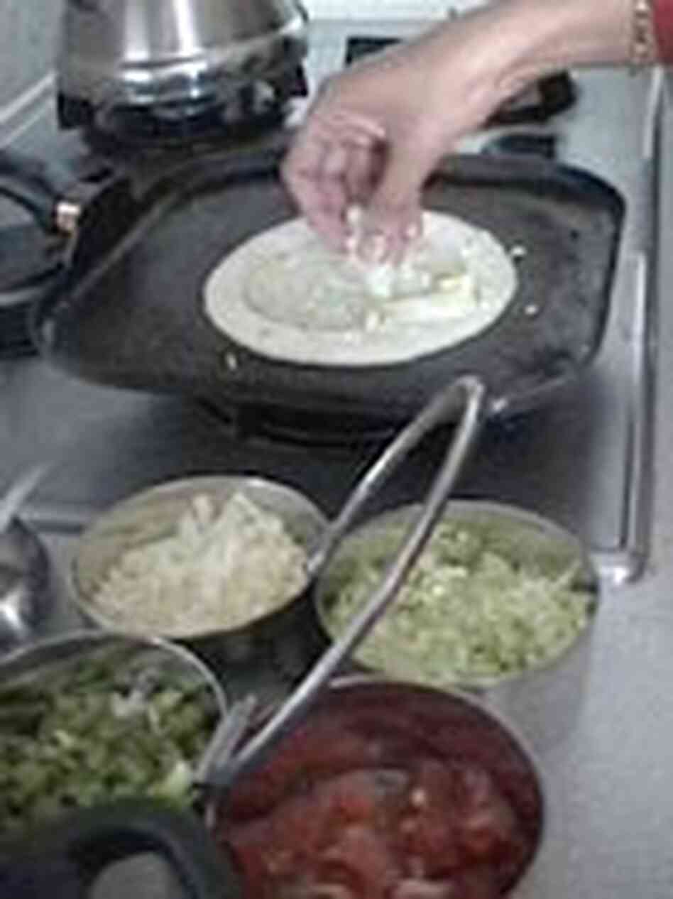 Narayan prepares vegetable dosa for lunch. Narayan prepares vegetable dosa for lunch.