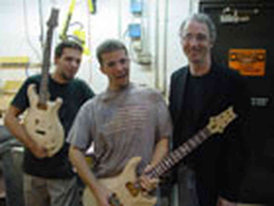 Smith with two of his guitar artisans. Smith with two of his guitar artisans.
