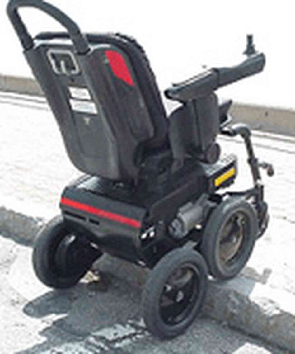 The iBOT rolls up a curb. The iBOT rolls up a curb.