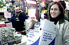 A shopper buys duct tape and plastic sheeting.