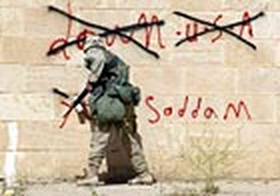 A U.S. soldier covers up anti-U.S., pro-Saddam graffiti in Awja, Iraq, in April 2003 A U.S. soldier covers up anti-U.S., pro-Saddam graffiti in Awja, Iraq, in April 2003